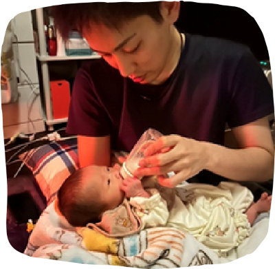 パパが赤ちゃんにミルクをあげている画像